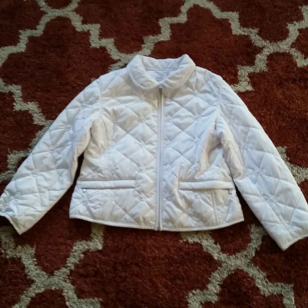 A young girls white puffy jacket.